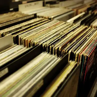 Rows of second-hand records packed into wooden bins in a shop