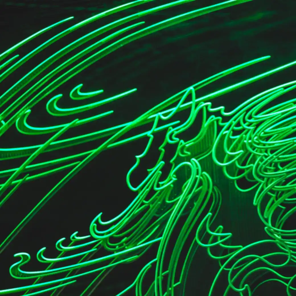 Green light trails looping across a black background